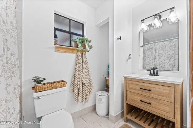 a bathroom with a toilet a sink and a mirror