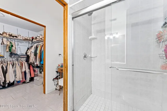 a view of walk in closet with clothes and shoes