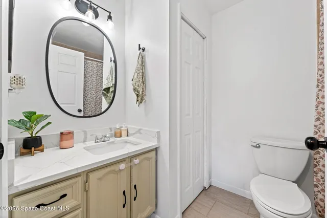 a bathroom with a toilet a sink and a mirror