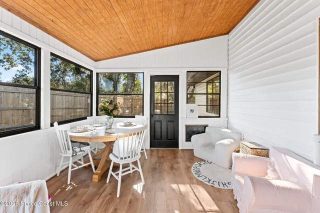 a dining room with furniture and wooden floor