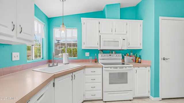 a kitchen with a stove and a white refrigerator