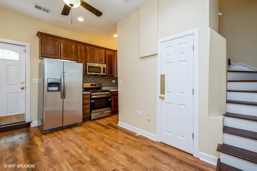 2149 North Lorel Avenue, Unit 2 Chicago, IL 60639 - Photo 3 of 9 a view of a kitchen with refrigerator and an oven