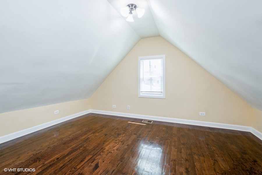 2149 North Lorel Avenue, Unit 2 Chicago, IL 60639 - Photo 6 of 9 an empty room with wooden floor and windows