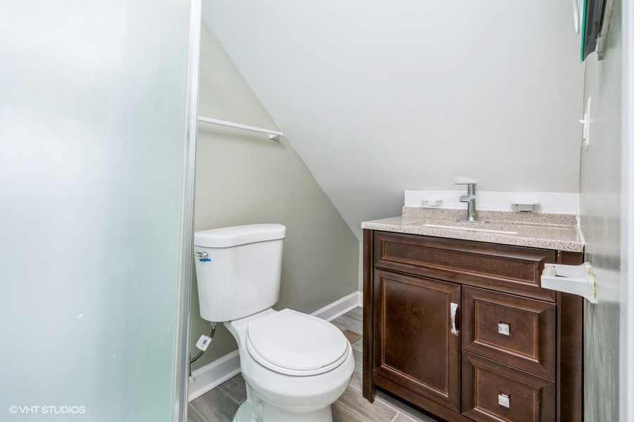 2149 North Lorel Avenue, Unit 2 Chicago, IL 60639 - Photo 8 of 9 a bathroom with a sink toilet and vanity