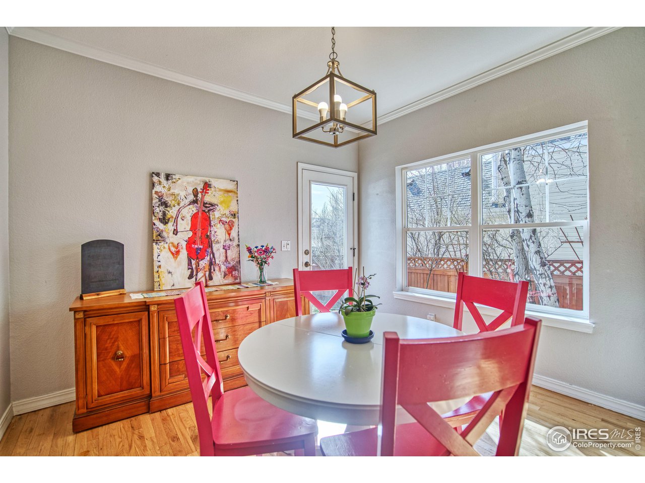 4944 Dakota Boulevard Boulder, CO 80304 - Photo 14 of 40 a view of a dining room with furniture a chandelier and wooden floor