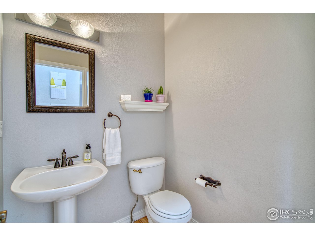 4944 Dakota Boulevard Boulder, CO 80304 - Photo 15 of 40 a bathroom with a toilet a sink and mirror