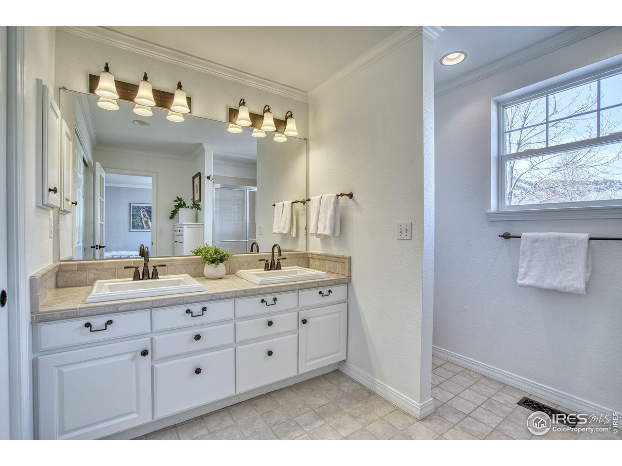 4944 Dakota Boulevard Boulder, CO 80304 - Photo 20 of 40 a bathroom with a double vanity sink mirror and