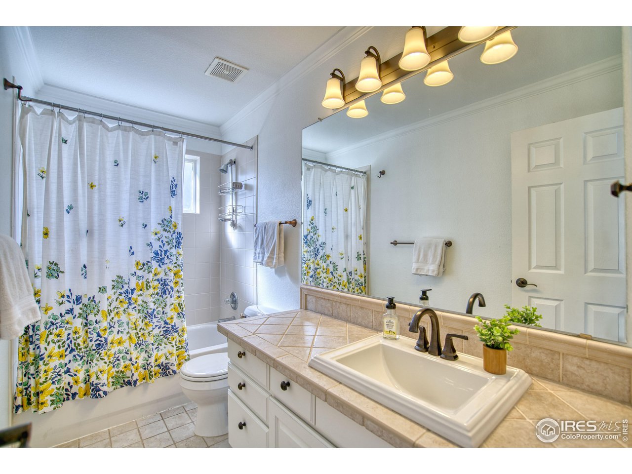 4944 Dakota Boulevard Boulder, CO 80304 - Photo 23 of 40 a bathroom with a sink mirror and vanity