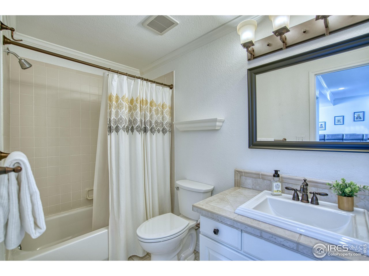 4944 Dakota Boulevard Boulder, CO 80304 - Photo 27 of 40 a bathroom with a sink vanity mirror and toilet