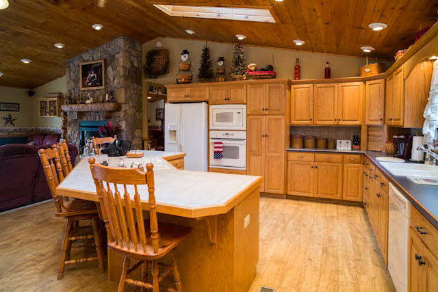 2252 Kerns Road Dayton, VA 22821 - Photo 7 of 31 a kitchen with stainless steel appliances kitchen island granite countertop a table chairs and a refrigerator