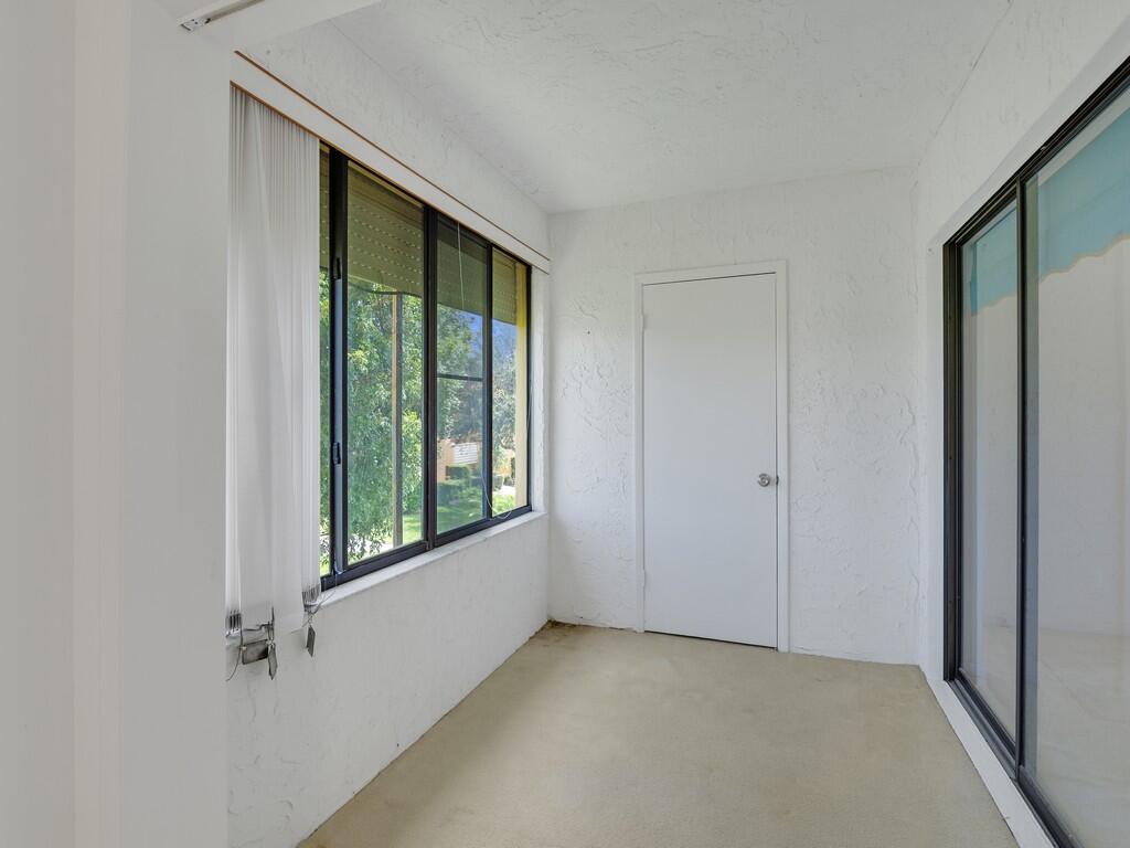 5373 Southeast Miles Grant Road, Unit 208 Stuart, FL 34997 - Photo 11 of 32 a view of an empty room with a window