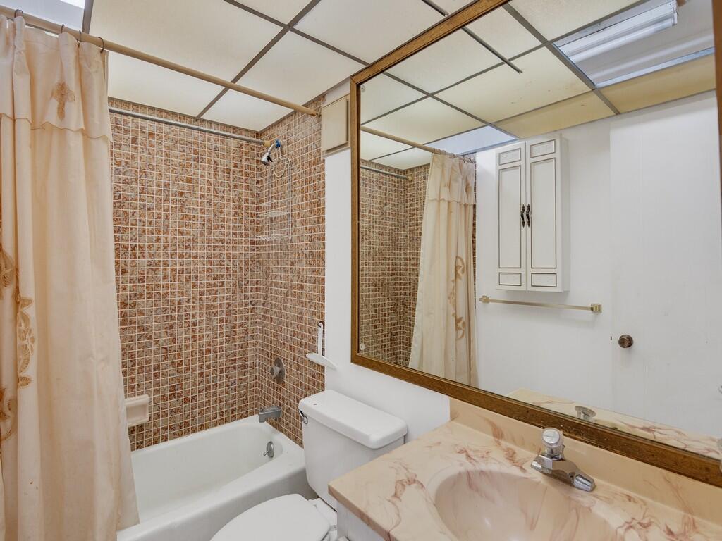 5373 Southeast Miles Grant Road, Unit 208 Stuart, FL 34997 - Photo 15 of 32 a bathroom with a sink toilet and shower