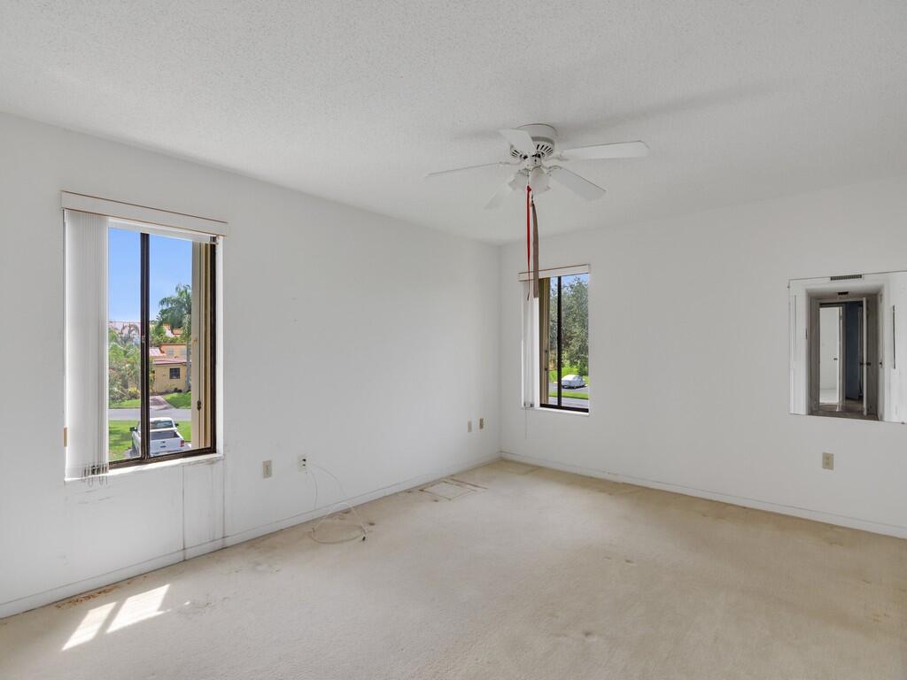 5373 Southeast Miles Grant Road, Unit 208 Stuart, FL 34997 - Photo 16 of 32 an empty room with windows