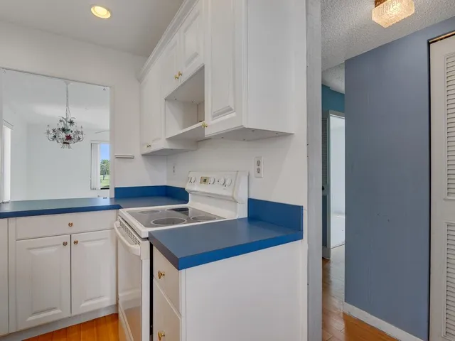 a kitchen with cabinets and white appliances