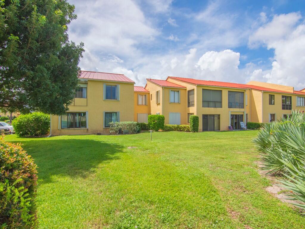 5373 Southeast Miles Grant Road, Unit 208 Stuart, FL 34997 - Photo 26 of 32 a view of a big yard with plants and large trees