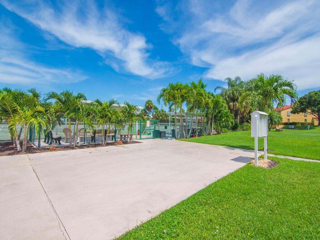 5373 Southeast Miles Grant Road, Unit 208 Stuart, FL 34997 - Photo 30 of 32 a street view with a big yard