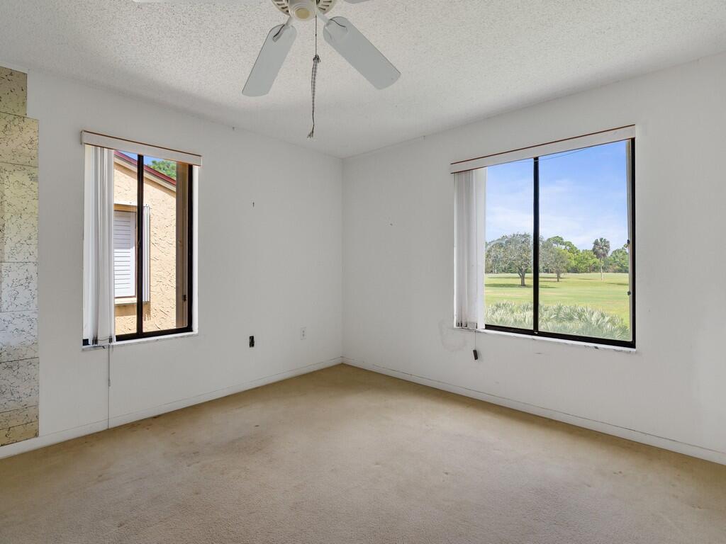 5373 Southeast Miles Grant Road, Unit 208 Stuart, FL 34997 - Photo 10 of 32 an empty room with a window
