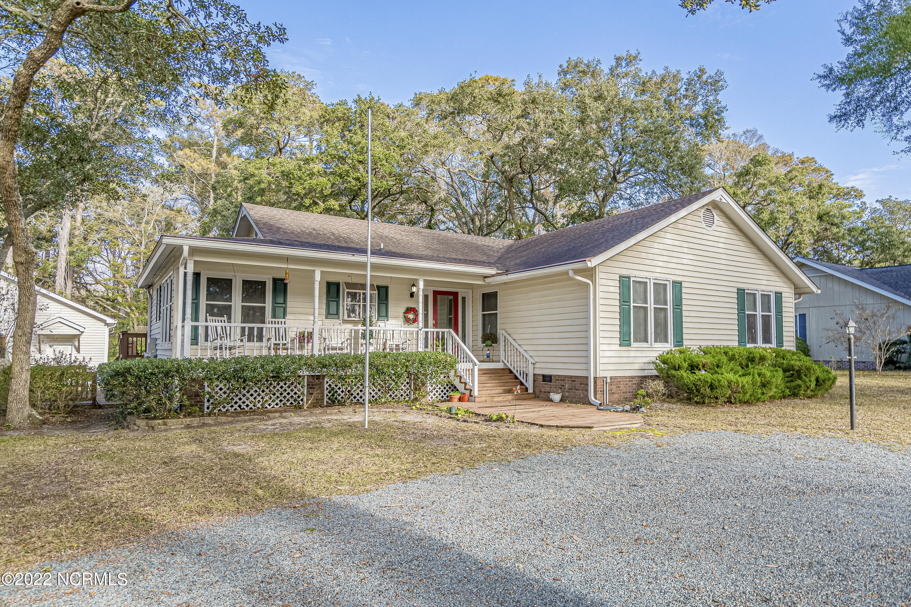 6824 Roberta Road Southwest Ocean Isle Beach, NC 28469 - Photo 1 of 37 Front elevation of this single family home with three bedrooms, two baths and a three car garage.