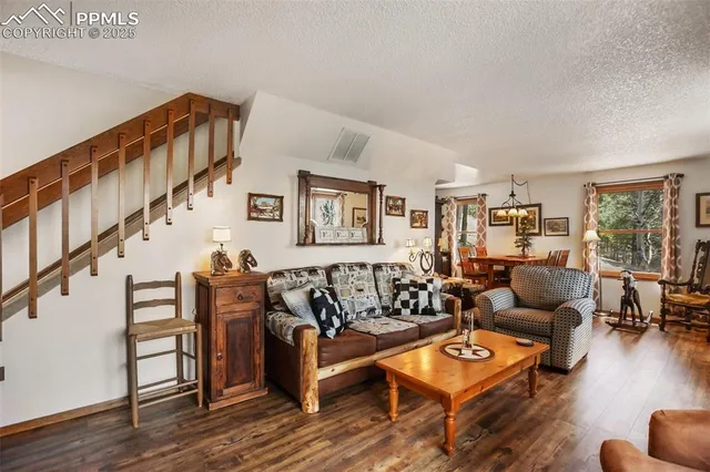 a living room with furniture and wooden floor