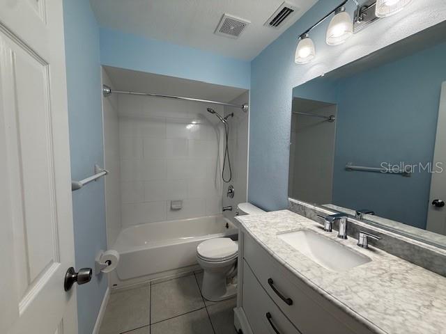 1029 10th Street Northwest, Unit B Largo, FL 33770 - Photo 14 of 20 a bathroom with a granite countertop sink toilet and shower