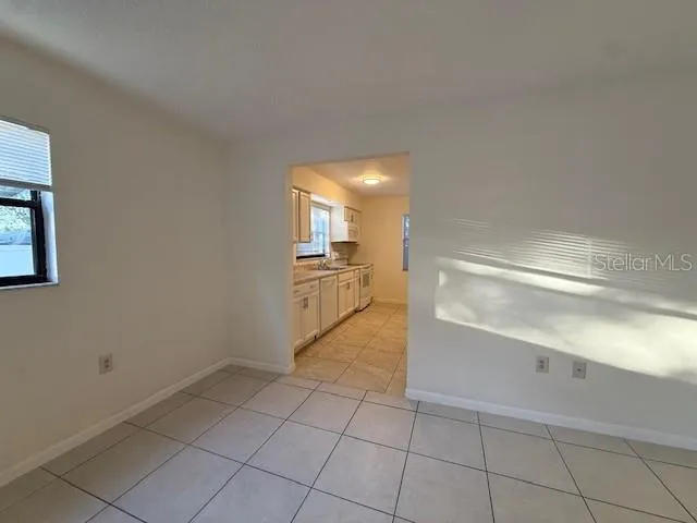 a view of a kitchen with a sink and dishwasher cabinets