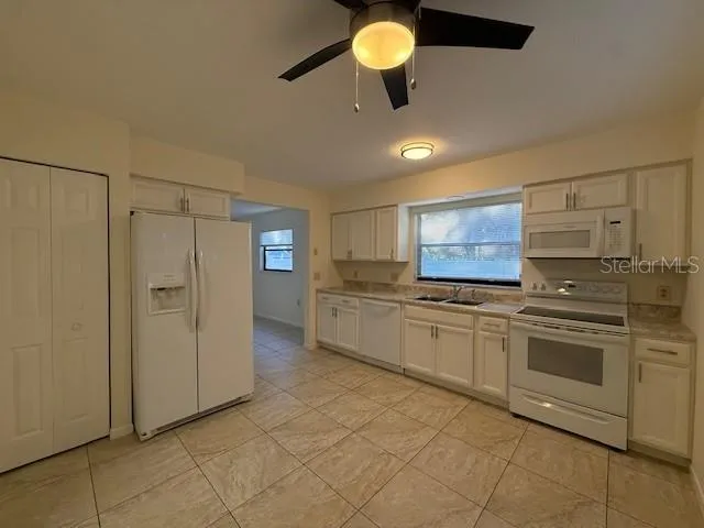 a kitchen with stainless steel appliances granite countertop a sink and cabinets
