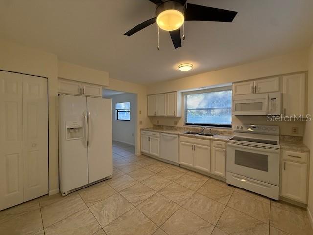 1029 10th Street Northwest, Unit B Largo, FL 33770 - Photo 8 of 20 a kitchen with stainless steel appliances granite countertop a sink and cabinets