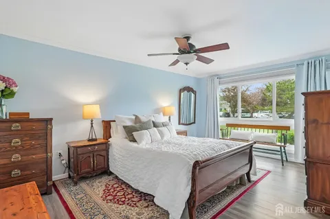 a bedroom with a bed and a lamp on the dresser