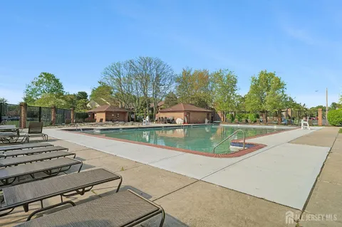 a view of a swimming pool with a yard