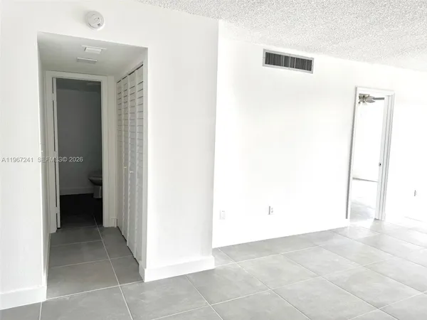 a view of a hallway to rooms