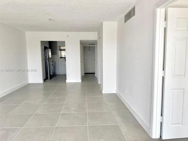 a view of a hallway with wooden shelves