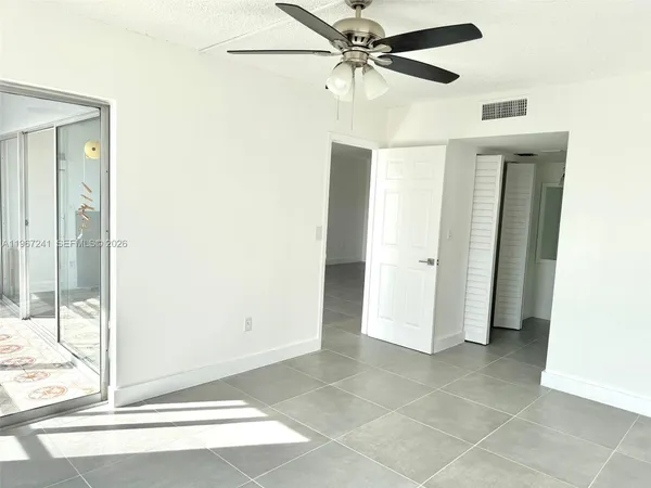 a view of a livingroom with a ceiling fan and window