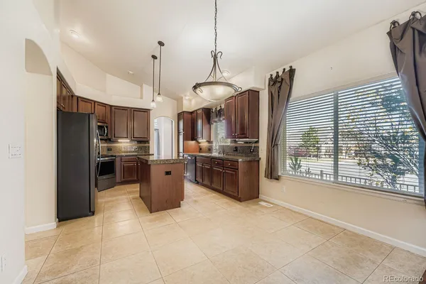 a living room with furniture ceiling fan and a window