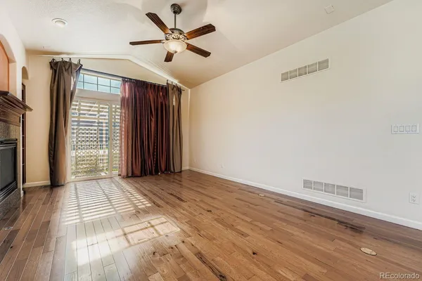a view of a living room with furniture and a fireplace