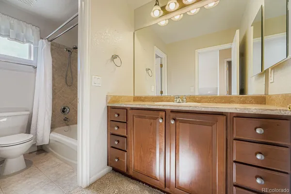 an empty room with fan and entrance