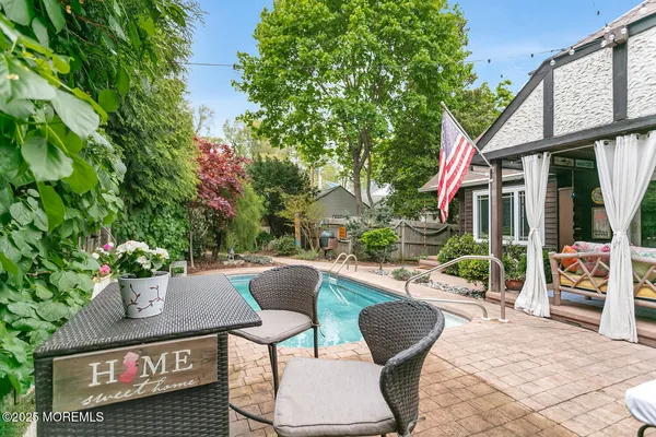 a view of a swimming pool with an outdoor seating