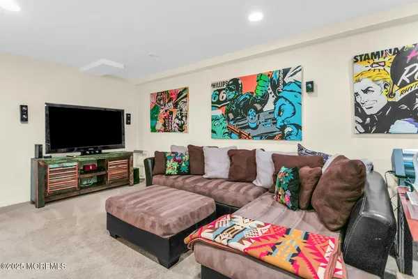 a living room with furniture and painting on the wall