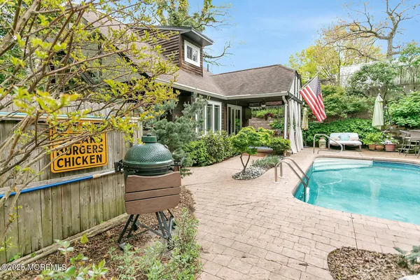 a backyard of a house with yard and trampoline