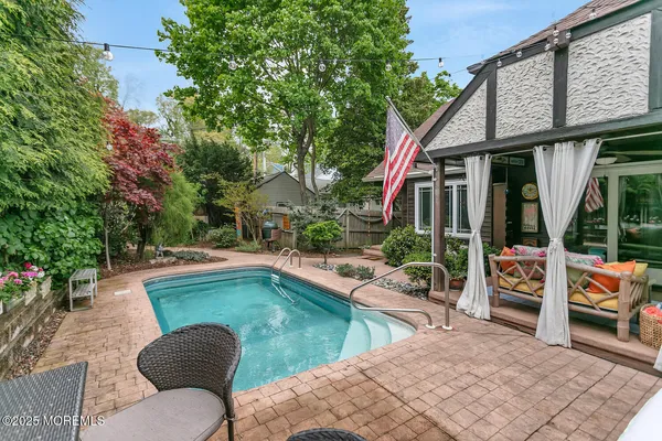 a view of a backyard with swimming pool