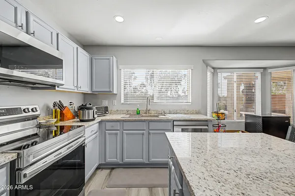 a kitchen with lots of counter top space and windows