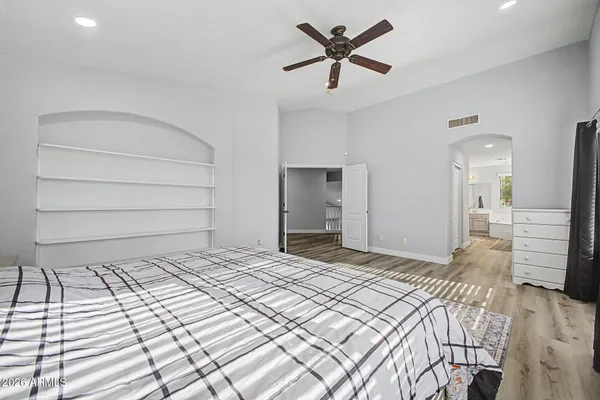 a bedroom with a bed and a chandelier