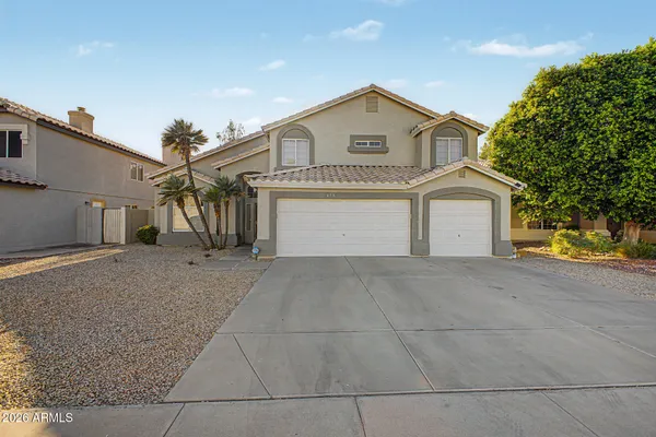 a view of a house with a yard and garage