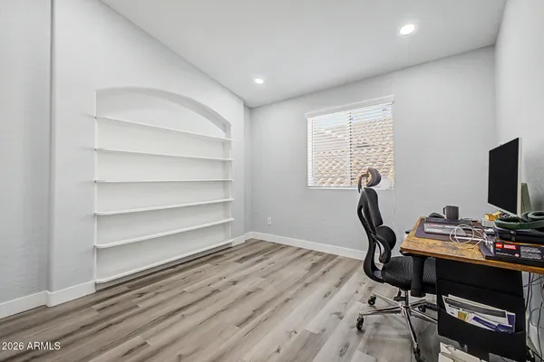 a view of a workspace with furniture and a window