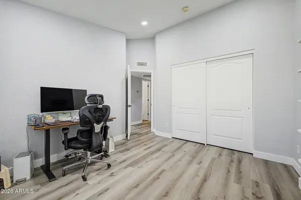 a view of a workspace with furniture and wooden floor