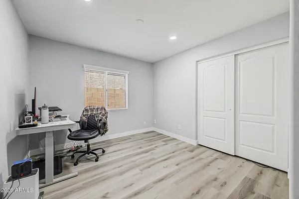 a workspace with wooden floor and a window