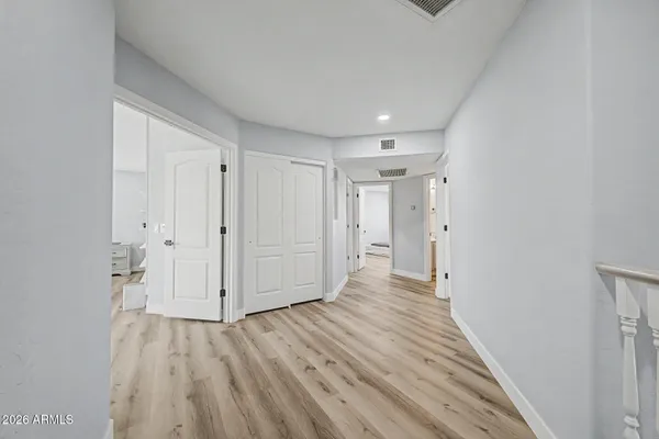 a view of a hallway with wooden floor