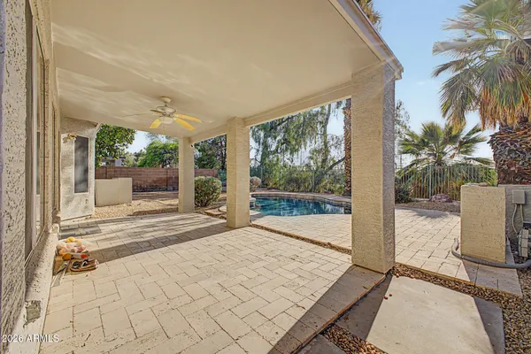 a view of a house with backyard and sitting area