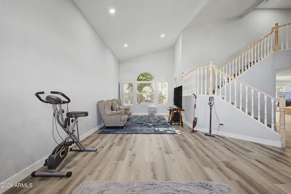 a view of hall way with furniture and wooden floor
