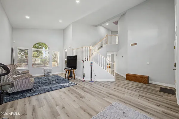 a view of a livingroom with wooden floor and a ceiling fan