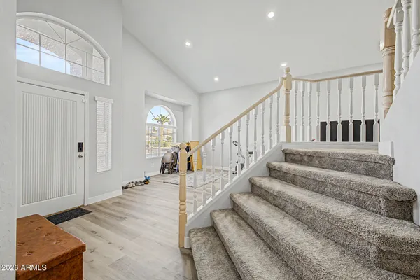 a view of entryway and hall with wooden floor